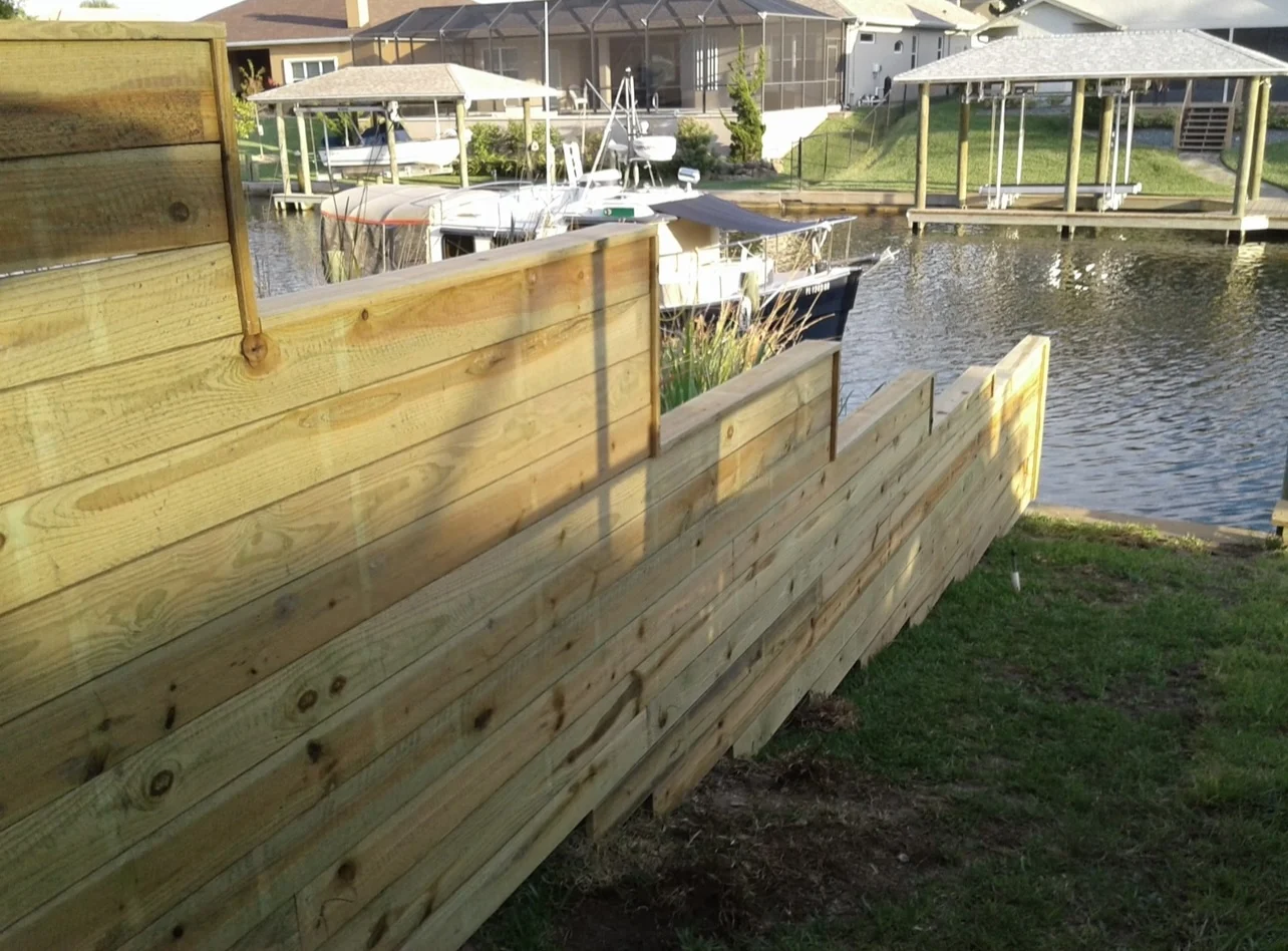 Waterfront horizontal board fence stepping down toward canal
