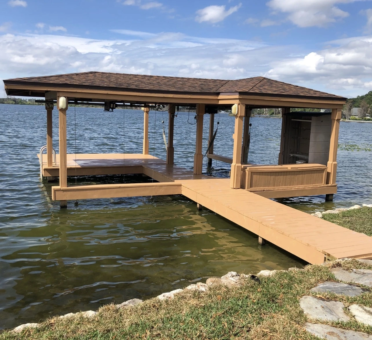 Gable-roof boat dock with lifts and walkways built for Gulf Coast weather on a Florida lake