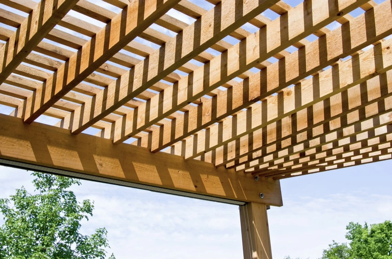 Pergola lattice close-up showing precise joinery, square cuts, and even shade lines