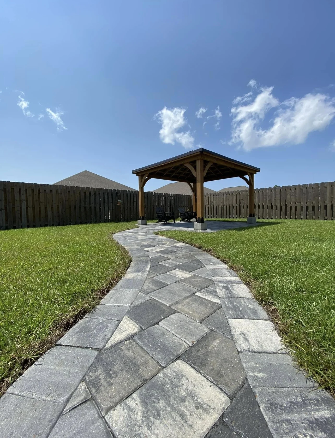 Curved paver walkway leading to pavilion